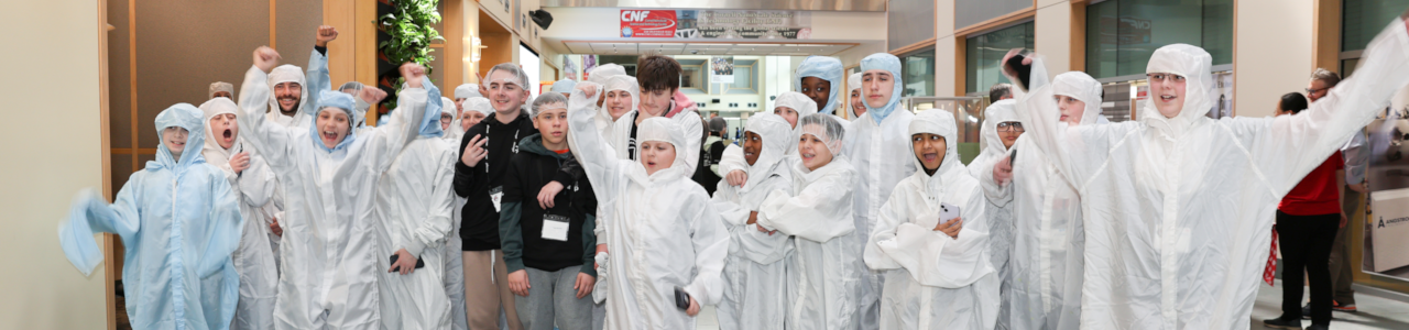 Students trying on Cleanroom suits in the Duffield atrium