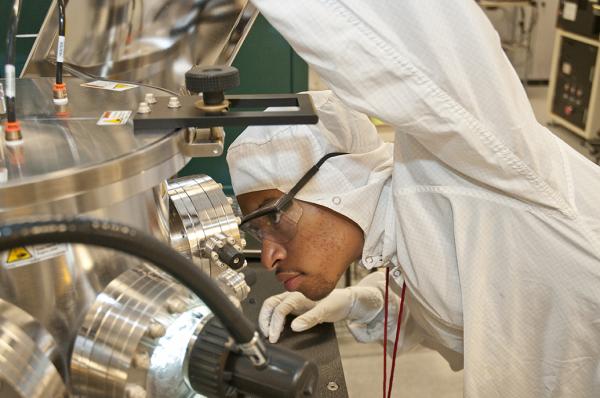 CNF REU intern Austin Little (2014) works with one of the CNF sputtering systems.