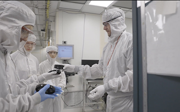 Tom Pennell works with ATLAS students in the CNF Cleanroom