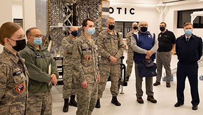 CAP members stand in front of the Peregrine Structural Test Model while touring Astrobotic.